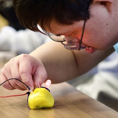 One of our LIFE Day Support participants exploring STEM skills during a community outing!