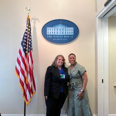 Margarita and Dominique poses with USA flag at White House