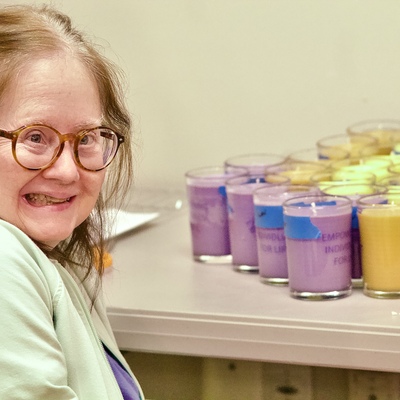 Shining bright! A participant proudly showcasing their freshly made Blue Elegance candles.