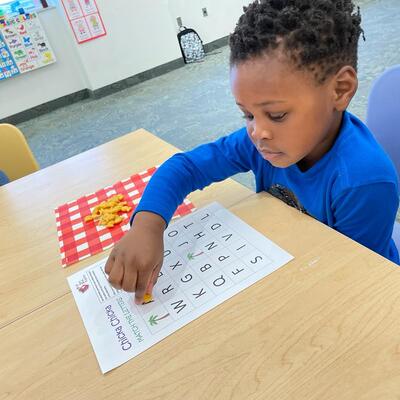 A student identifying letters.