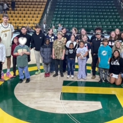 Foster/adoptive/kinship meeting GMU basketball players after a game with AXiD sisters