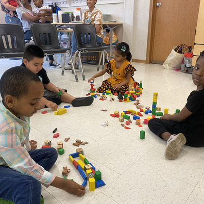 Students playing together with connecting toys in class.