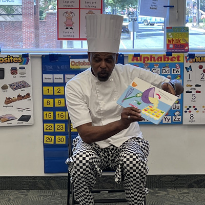 Chef Dennis from Chantel's Bakery reading to AART students.