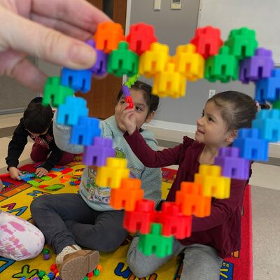 Student playing with connecting toys.