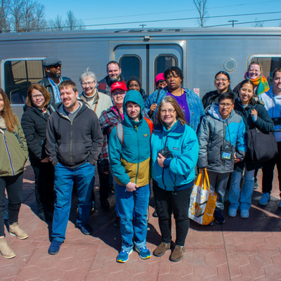 Travel training group standing in front of metro train